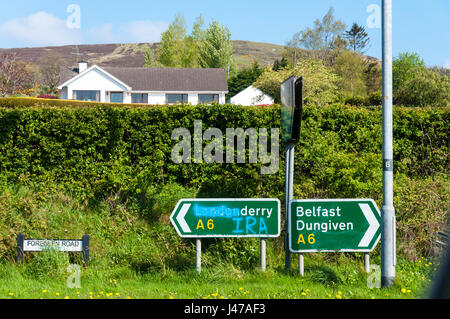 Defaced road sign near Claudy in County Londonderry, Northern Ireland UK. Stock Photo