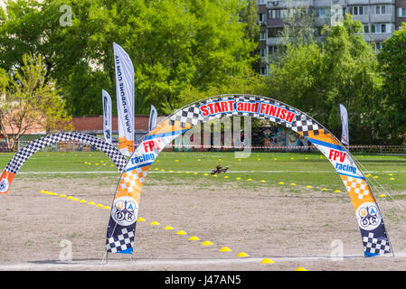 Kyiv, Ukraine - April 29, 2017: Drone quadrocopter flies through the Racing gates during the Drone Festival in Kyiv, Ukraine. Stock Photo