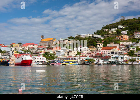 Boats in the Carenage surrounded by colourful buildings on a hill in St. George's, capital of Grenada, West Indies, Caribbean Stock Photo