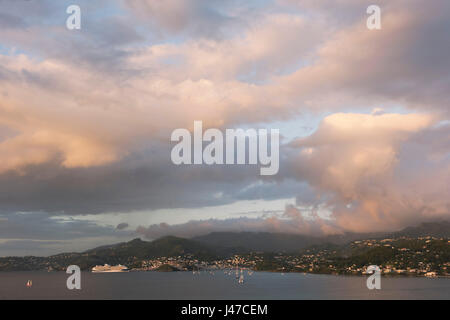 A dramatic pink cloud formation over Grand Anse at sunset looking toward St. George's, Grenada, West Indies, Caribbean Stock Photo