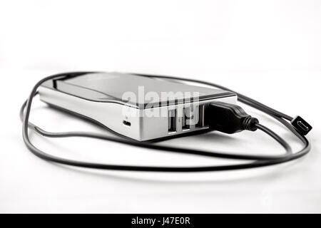 Isolated black powerbank with plugged usb cable Stock Photo