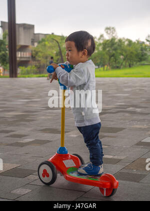 Yilan, Taiwan - October 14, 2016: The Taiwanese boy on a scooter Stock Photo