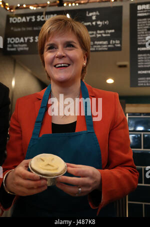 SNP Leader Nicola Sturgeon holds a haggis pie featuring the party's logo that she helped to make on a campaign visit to Table 13 Express in Kirkintilloch, East Dunbartonshire. Stock Photo