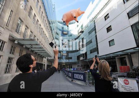 People take photos of Algie the inflatable pig outside BBC Broadcasting House in London, which is to publicise the Pink Floyd Exhibition: Their Mortal Remains, which runs from May 13 to October 1 2017 at the V&amp;A in London. Stock Photo
