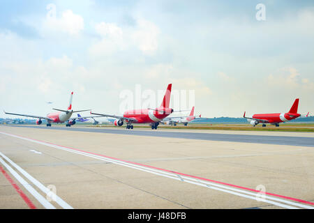 Airplanes at runway in an airport waiting for takeoff Stock Photo