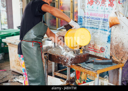 GEORGE TOWN, MALAYSIA - MARCH 23: Man prepare the fish for sale at the wet market on March 23, 2016 in George Town, Malaysia. Stock Photo