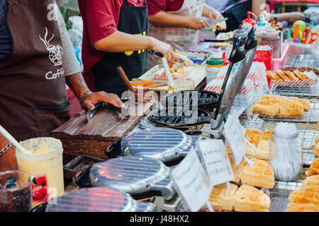 CHIANG MAI, THAILAND - AUGUST 21: Chefs cooks and sells waffles at the Sunday Market (Walking Street) on August 21, 2016 in Chiang Mai, Thailand. Stock Photo