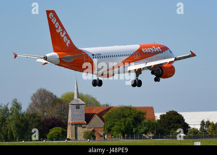 easyJet Airbus A319 jet plane G-EZFW landing at London Southend Airport, Essex, in blue sky Stock Photo