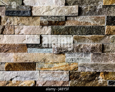 Stone wall texture or background with yellowish, dark, gray and white colors Stock Photo