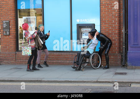 Maldon, Essex, UK. 10th May, 2017. The Gimp Man of Essex appears in the Essex town of Maldon. The mysterious character dressed from head to toe in black latex was seen walking up and down Maldon High Street. The Gimp Man donates a £1 to the mental health charity Mind for each selfie that is taken with him and their was no shortage of people who had their picture taken. Credit: David Johnson/Alamy Live News Stock Photo