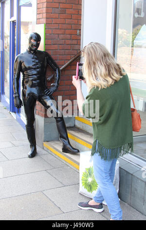 Maldon, Essex, UK. 10th May, 2017. The Gimp Man of Essex appears in the Essex town of Maldon. The mysterious character dressed from head to toe in black latex was seen walking up and down Maldon High Street. The Gimp Man donates a £1 to the mental health charity Mind for each selfie that is taken with him and their was no shortage of people who had their picture taken. Credit: David Johnson/Alamy Live News Stock Photo