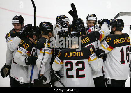 Cologne, Germany. 10th May, 2017. Germany's players celebrate after winning the 2017 IIHF Ice Hockey World Championship Preliminary Round Group A Game between Slovakia and Germany in Cologne, western Germany, on May 10, 2017. Germany won 3-2. Credit: Ulrich Hufnagel/Xinhua/Alamy Live News Stock Photo