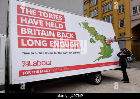 London, UK.  11 May 2017.  A TV cameraman at work at the unveiling of a new campaign poster for Labour’s General Election campaign at a press call on the South Bank.   Credit: Stephen Chung / Alamy Live News Stock Photo