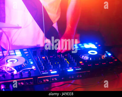 Dj mixes the track in the nightclub at a party Stock Photo