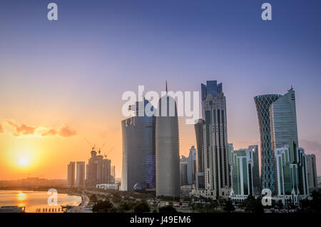 The skyscrapers in the skyline of the commercial center of Doha, the capital of the Arabian Gulf country Qatar at sunset. Stock Photo