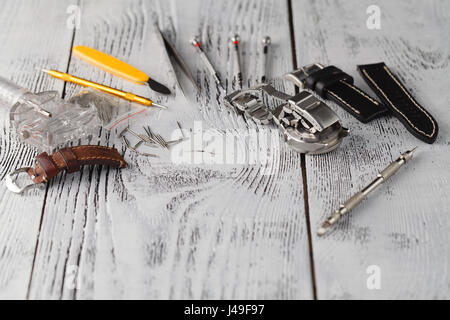 watchmaker tools on wood texture and free space for text edit Stock Photo