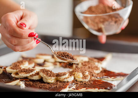 pastry chef covering cake with melted chocolate Stock Photo
