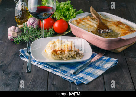 Relax dinner for one. Lasagna with wine glass Stock Photo