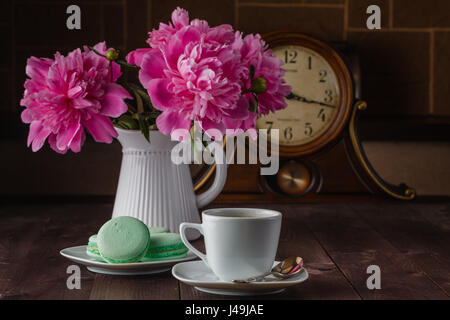 cup of coffee and flowers (peonies) on daark wooden table Stock Photo