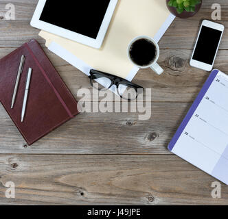 Flat lay view of working desktop with basic pen and paper with some technology Stock Photo