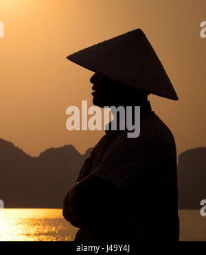 HA LONG BAY, VIETNAM - CIRCA SEPTEMBER 2014:  Profile of Vietnamese man in Halong Bay Stock Photo