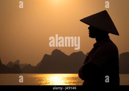 HA LONG BAY, VIETNAM - CIRCA SEPTEMBER 2014:  Profile of Vietnamese man in Halong Bay Stock Photo