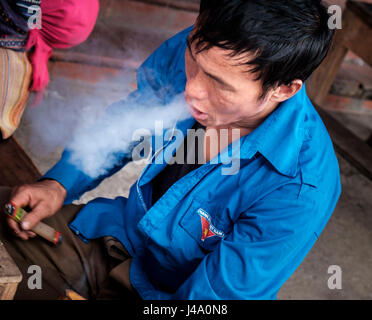 BAC HA, VIETNAM - CIRCA SEPTEMBER 2014:  Vietnamese man smoking at the Bac Ha sunday market, the biggest minority people market in Northern Vietnam Stock Photo
