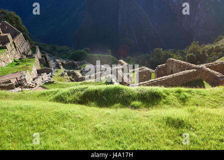 Green grass on machu picchu ancient city. Old stone village ruins Stock Photo