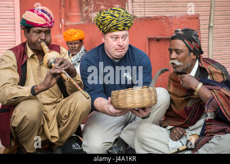 Tourist with snake charmers in Jaipur, India. Stock Photo