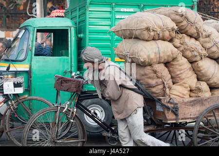 Transporting goods through the busy streets of New Delhi, India. Stock Photo