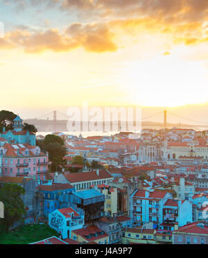 View of Lisbon at sunset with sun in the sky. Portugal Stock Photo