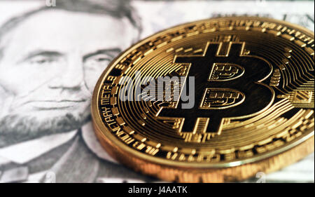 Bitcoin on five  dollar banknote. Trading concept Stock Photo