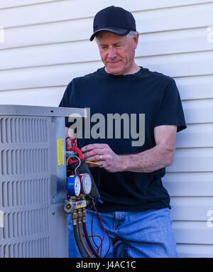 HVAC Technician Repairing Air Conditioning Stock Photo