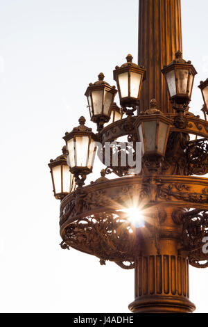 Early morning sun shines through a street lamp post in Berlin, Germany. Stock Photo