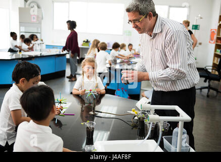 Group of diverse kindergarten students learning experiment in science laboratory class Stock Photo