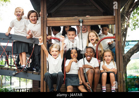 Group of diverse kindergarten students at playground together Stock Photo