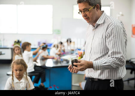 Group of diverse kindergarten students learning experiment in science laboratory class Stock Photo