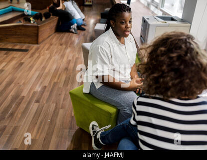 Students girls talking at library Stock Photo