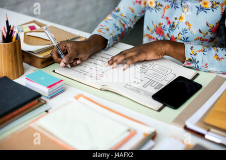 Hands Working on Office Desk with Notebooks and Stationery on White Table Stock Photo