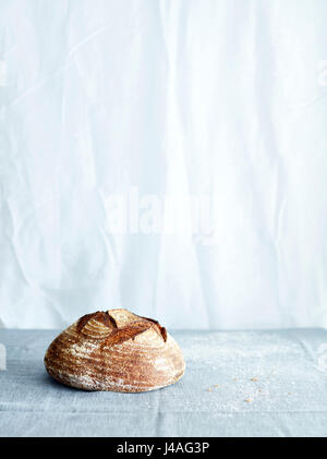 Sourdough loaf on tablecloth Stock Photo