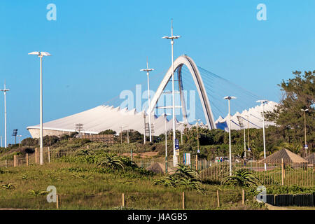 DURBAN, SOUTH AFRICA - APRIL 21, 2017:  Early morning view of dune vegetation against Moses Mahbida Stadium and blue sky in Durban, South Africa. Stock Photo