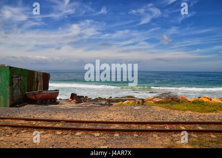 A railway line runs alongside the beach on False Bay, South Africa Stock Photo