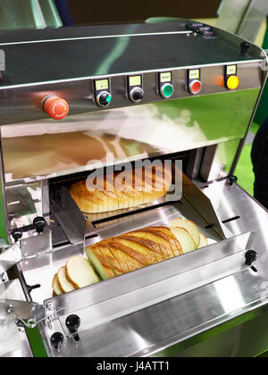 Sliced Bread in Cutting Machine / Industrial Bread Slicer in Supermarket  with Bread Crumbs. Ready to Use Stock Photo - Alamy