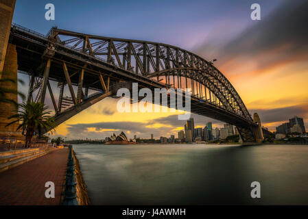 Sunset skyline of Sydney downtown  with Harbour Bridge, NSW, Australia. Long exposure. Stock Photo