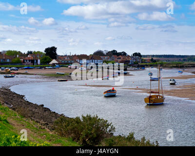 The North Norfolk coastline at Burnham Overy Staithe in eastern England UK with boats moored in the creek Stock Photo