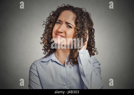 Skeptic. Doubtful woman looking at you camera isolated grey wall background. Negative human emotion facial expression feeling body language attitude Stock Photo