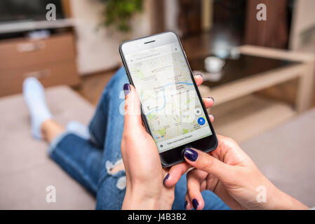 Black iPhone 7 Plus with Google Maps in hands. Stock Photo