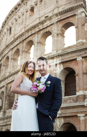 Bride and groom wedding poses in front of Colosseum, Rome, Italy Stock Photo