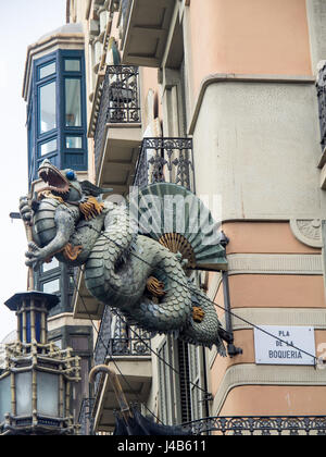 Ornate Chinese dragon on the corner of the Casa Bruno Cuadros, a building that was once an umbrella shop in the 1880s, located on La Rambla, Barcelona. Stock Photo