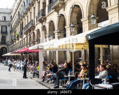 Tourists enjoying al fresco dining in Placa Reial , Barcelona, Spain. Stock Photo
